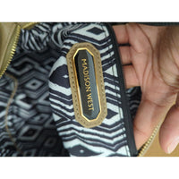Madison West Beige Faux Leather Wristlet Clutch With Black & White Geometric Lining And Zip Closure