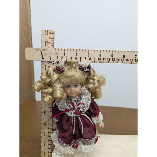 Porcelain Blonde Doll In Burgundy Lace Dress With Accessories